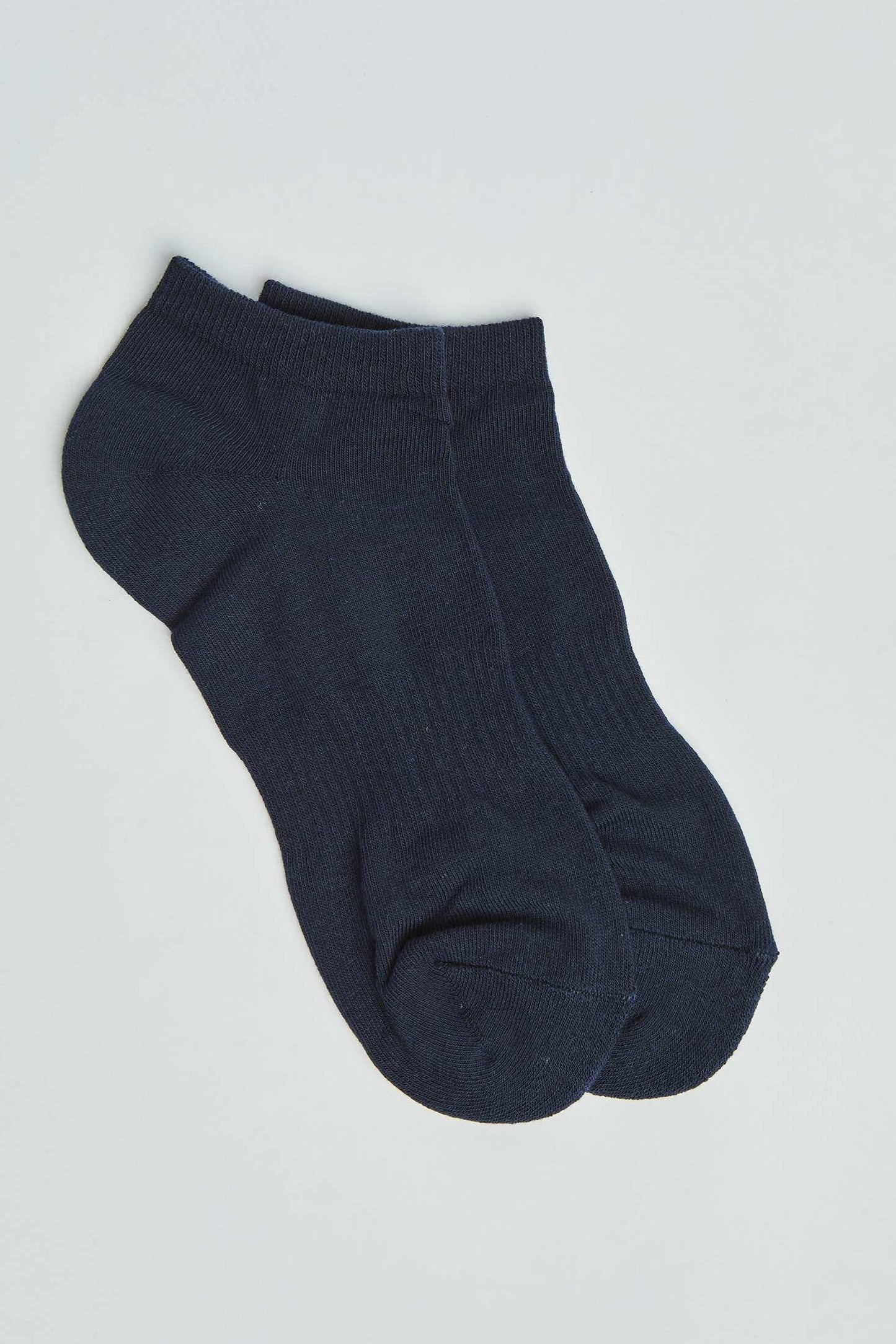Pair of plain black ankle socks on a white background