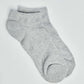 Pair of light grey ankle socks on a plain background, casual cotton blend socks