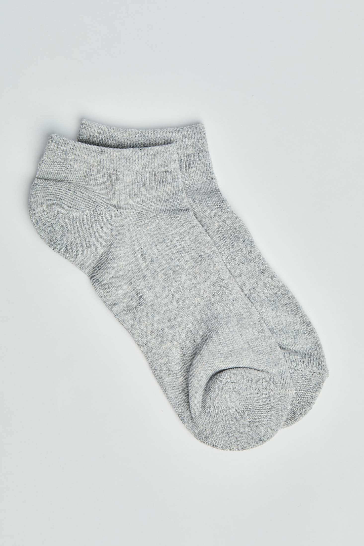 Pair of light grey ankle socks on a plain background, casual cotton blend socks