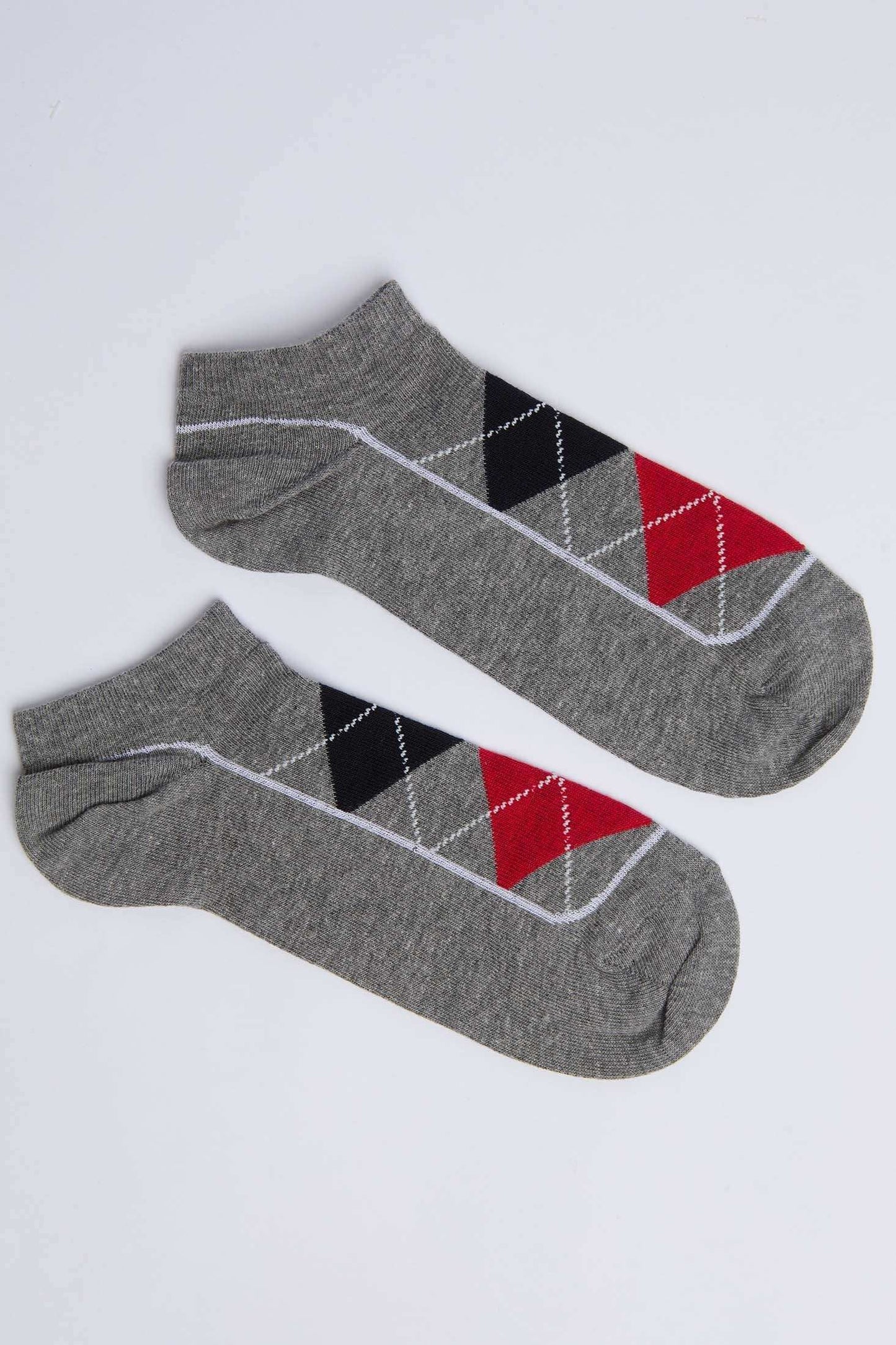Grey ankle socks with black, red, and white argyle pattern on white background