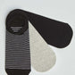 Three pairs of low cut socks in black, grey, and black with white stripes, flat lay