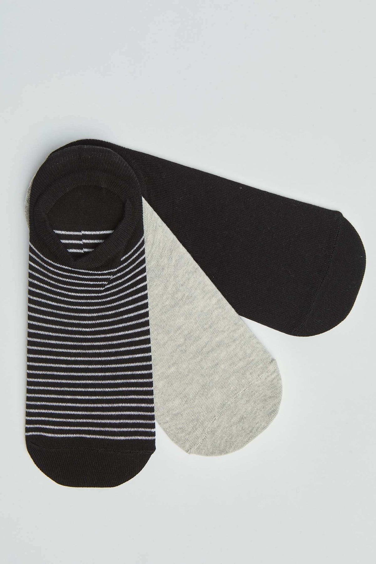Three pairs of low cut socks in black, grey, and black with white stripes, flat lay