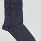 Pair of navy blue socks with subtle diamond pattern on a plain background