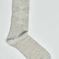 Light grey argyle pattern dress sock on white background, casual men's accessory