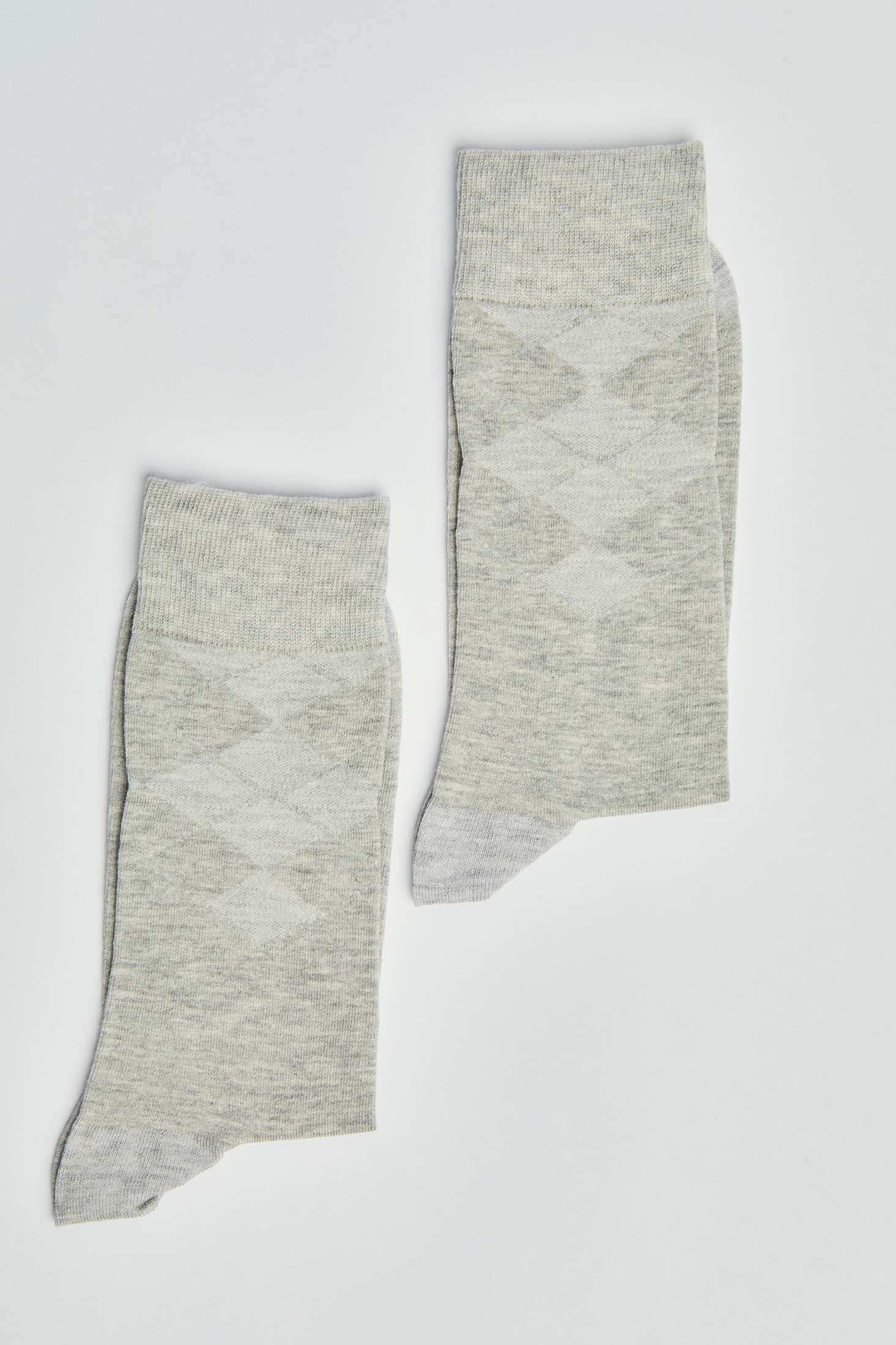 Pair of light grey argyle socks with ribbed cuffs on a plain white background