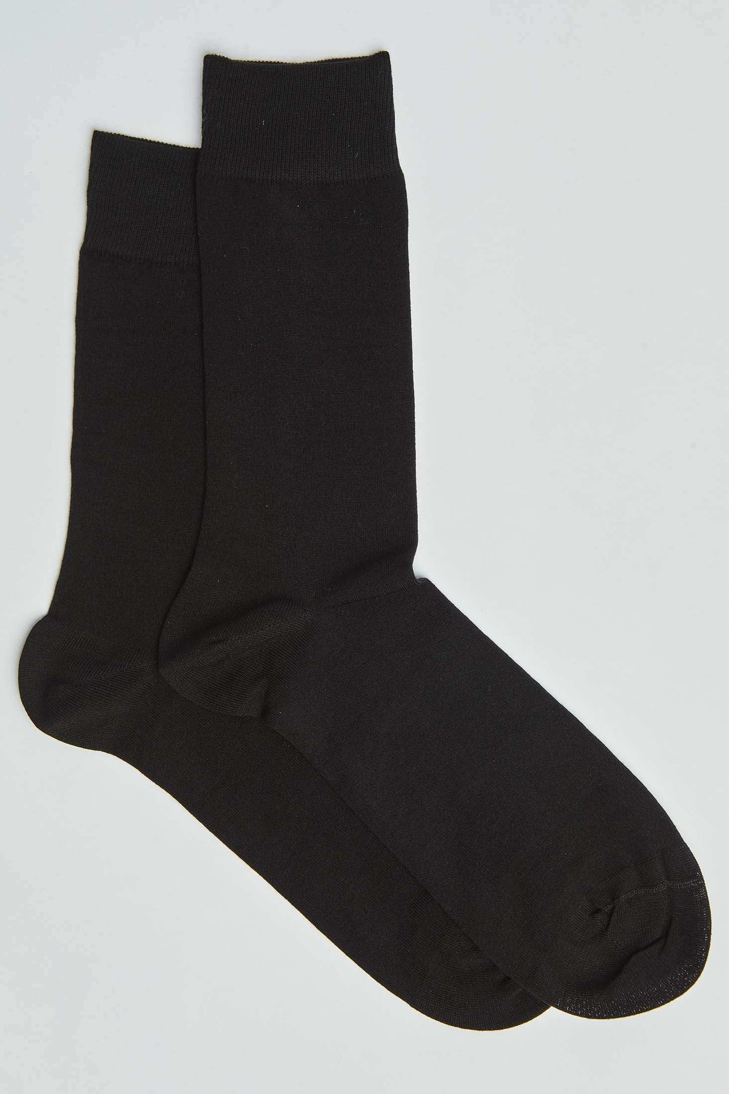 Pair of plain black crew socks on a white background, men's casual accessories