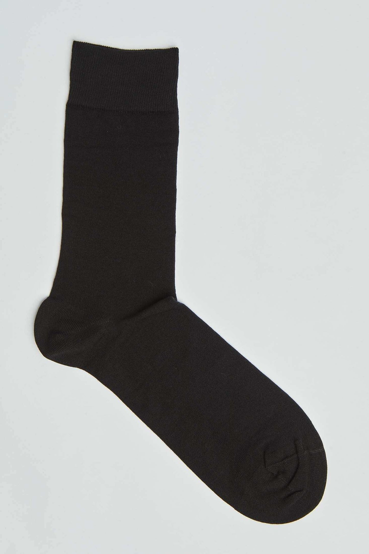 Single plain black crew sock on a white background, men's fashion accessory
