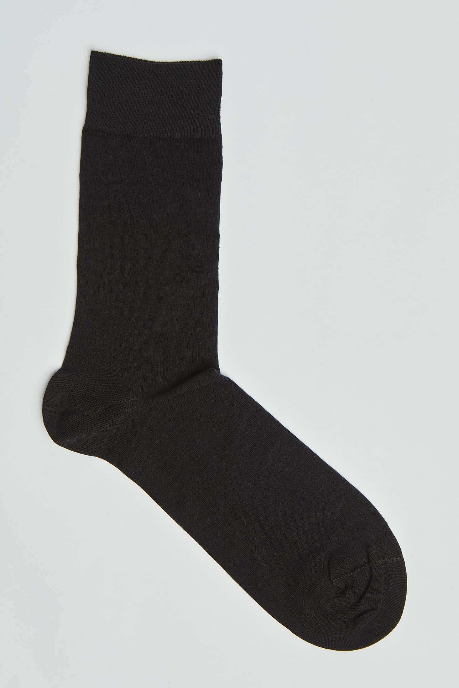 Single plain black crew sock on a white background, men's fashion accessory