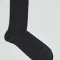 Single black cotton crew sock on white background, men's and women's fashion accessory
