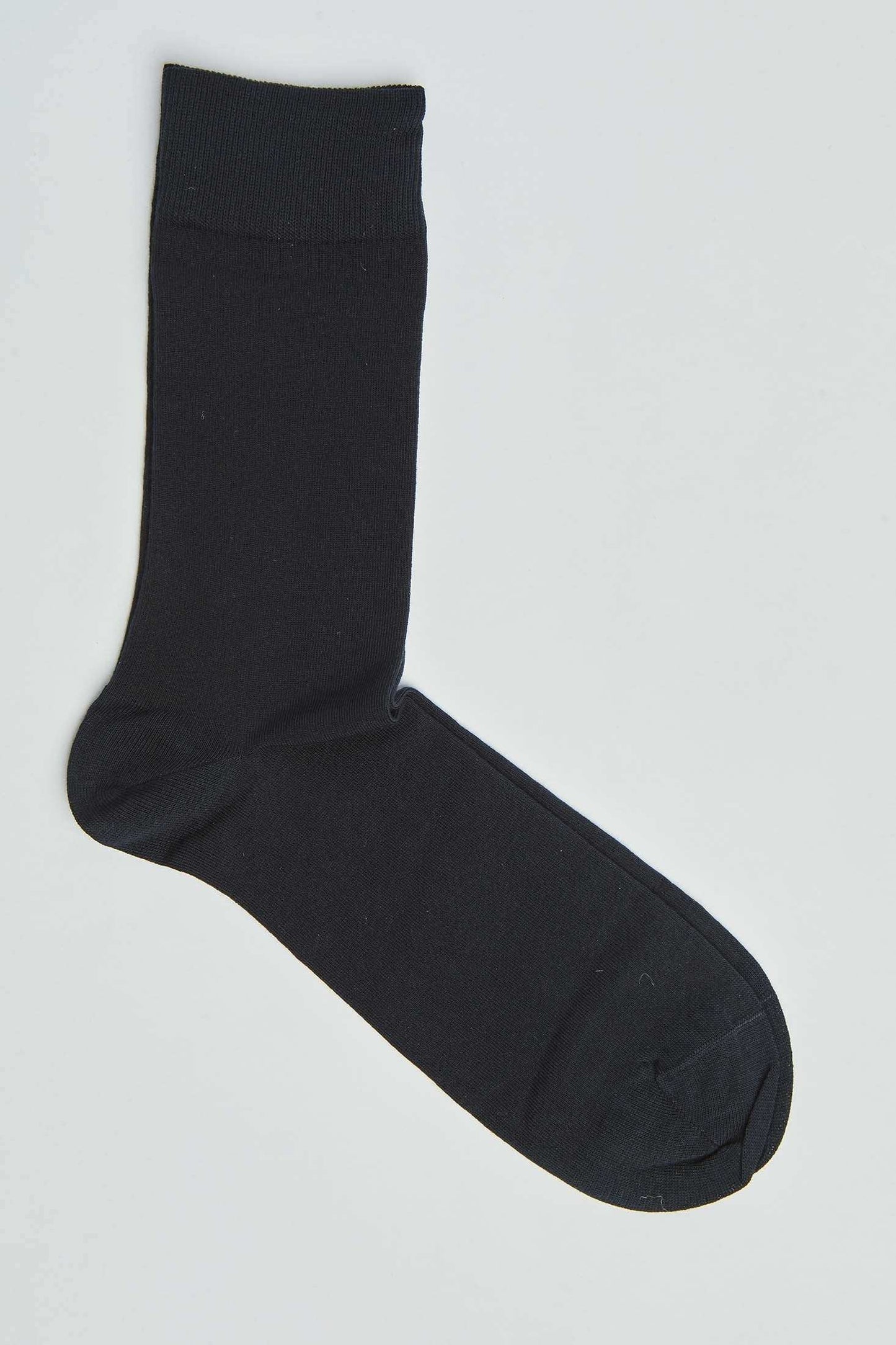 Single black cotton crew sock on white background, men's and women's fashion accessory