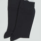 Pair of plain black men's dress socks on a light background