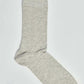 Plain light grey crew sock on white background, casual men’s or women’s hosiery