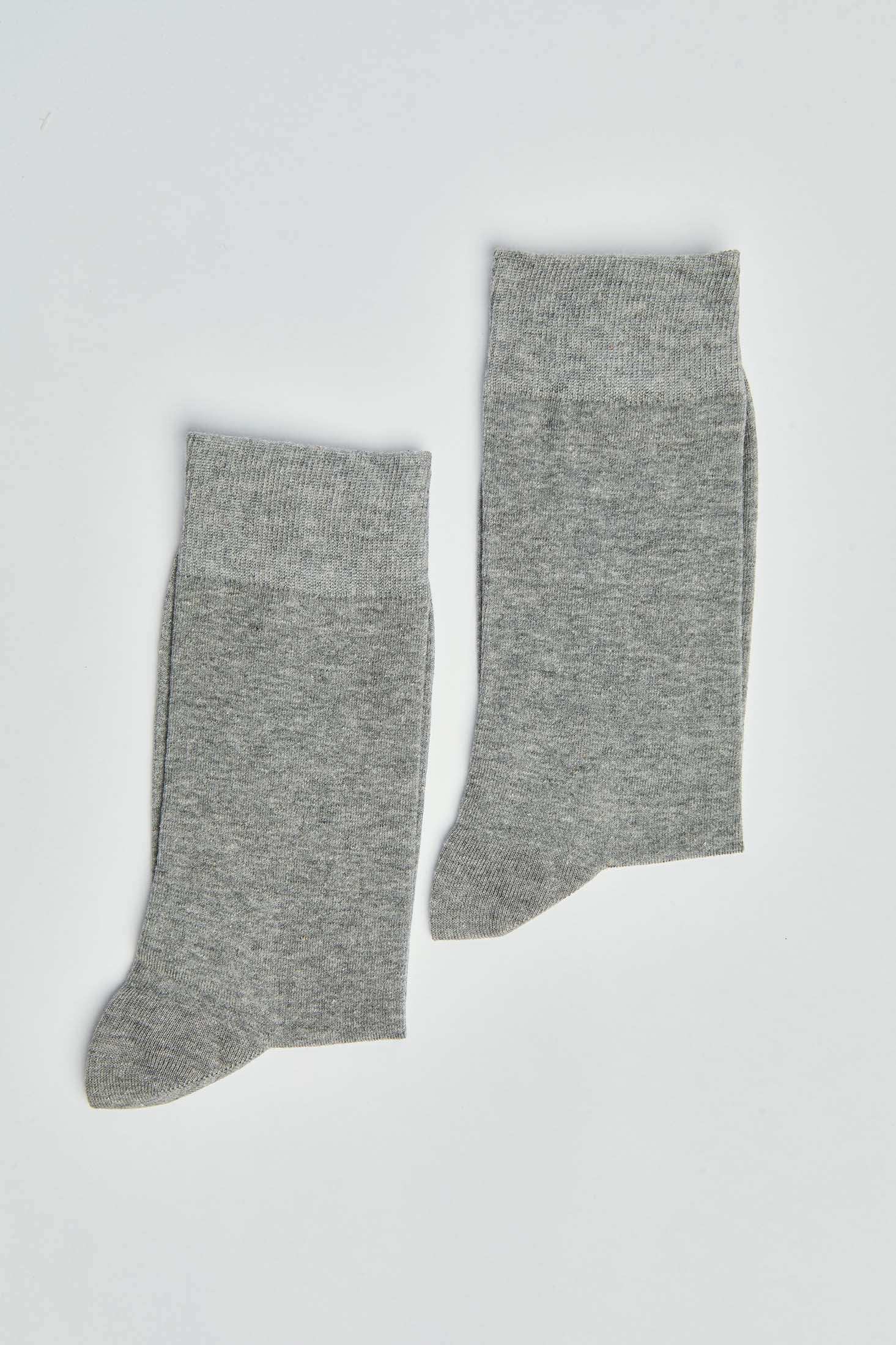 Pair of plain grey cotton socks with ribbed cuffs on a white background