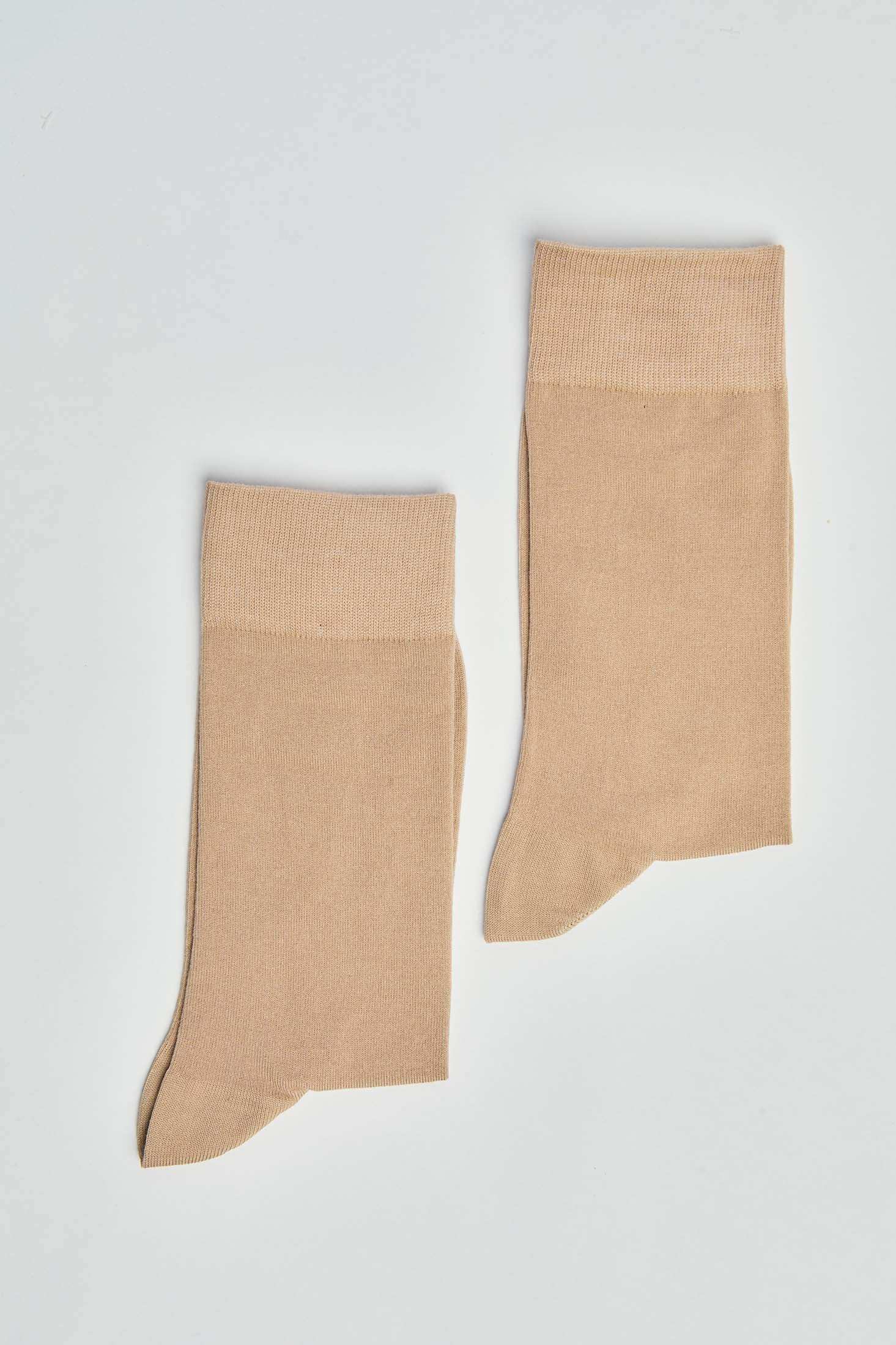 Pair of beige crew socks on white background, casual men's or women's socks