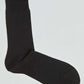 Classic black crew sock for men and women on a plain background