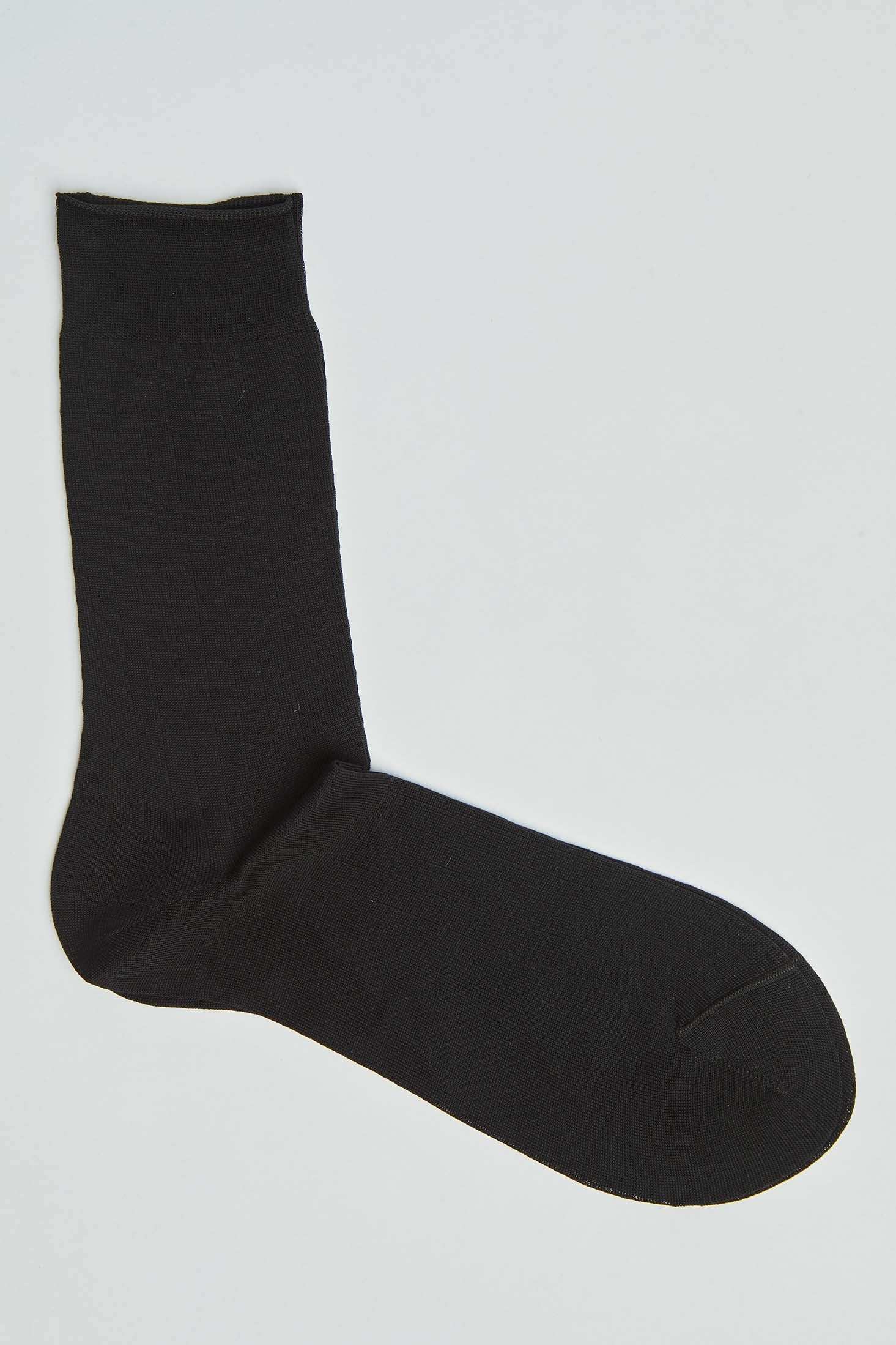 Classic black crew sock for men and women on a plain background