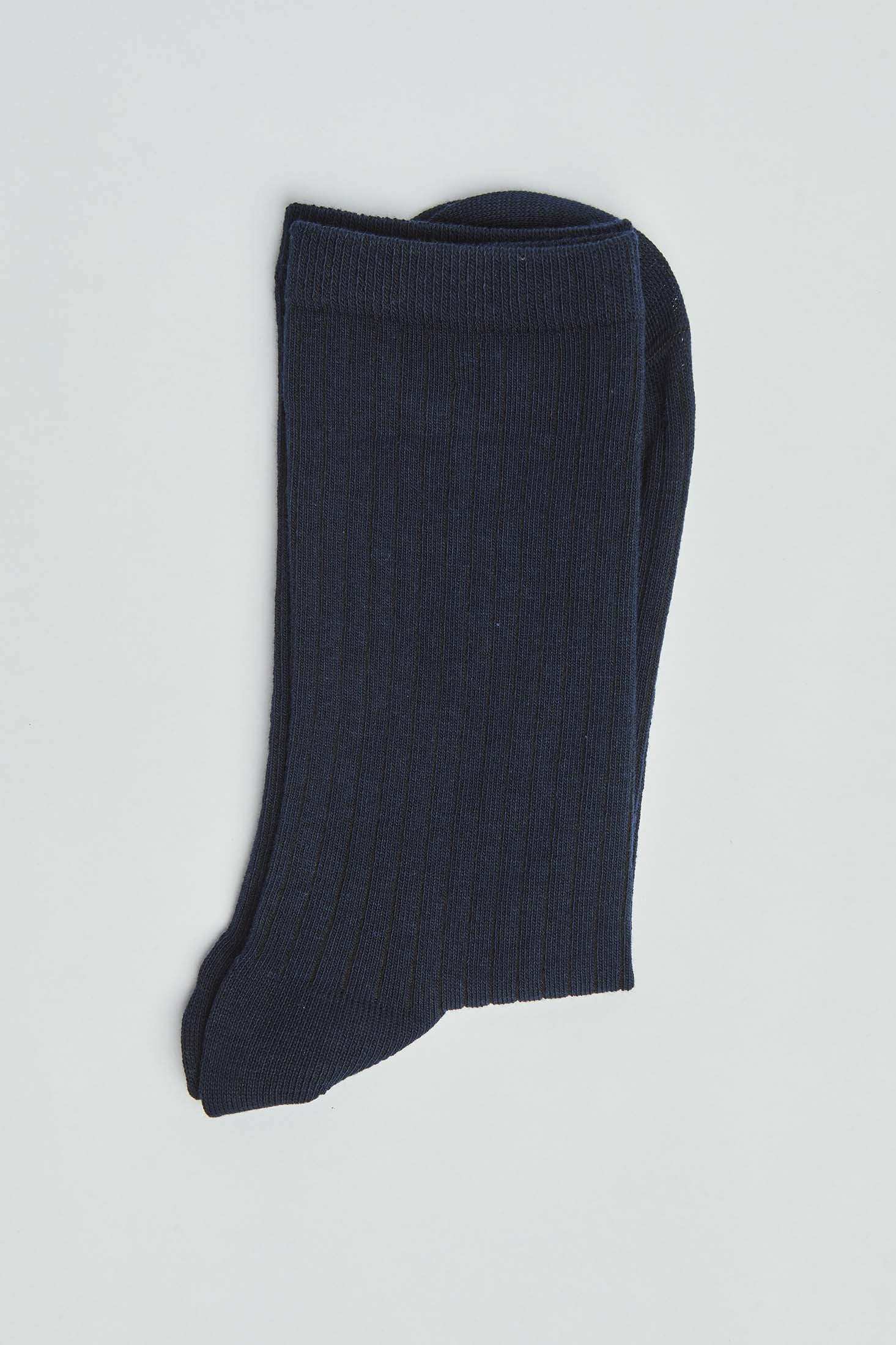 Pair of dark navy ribbed socks on a plain light background