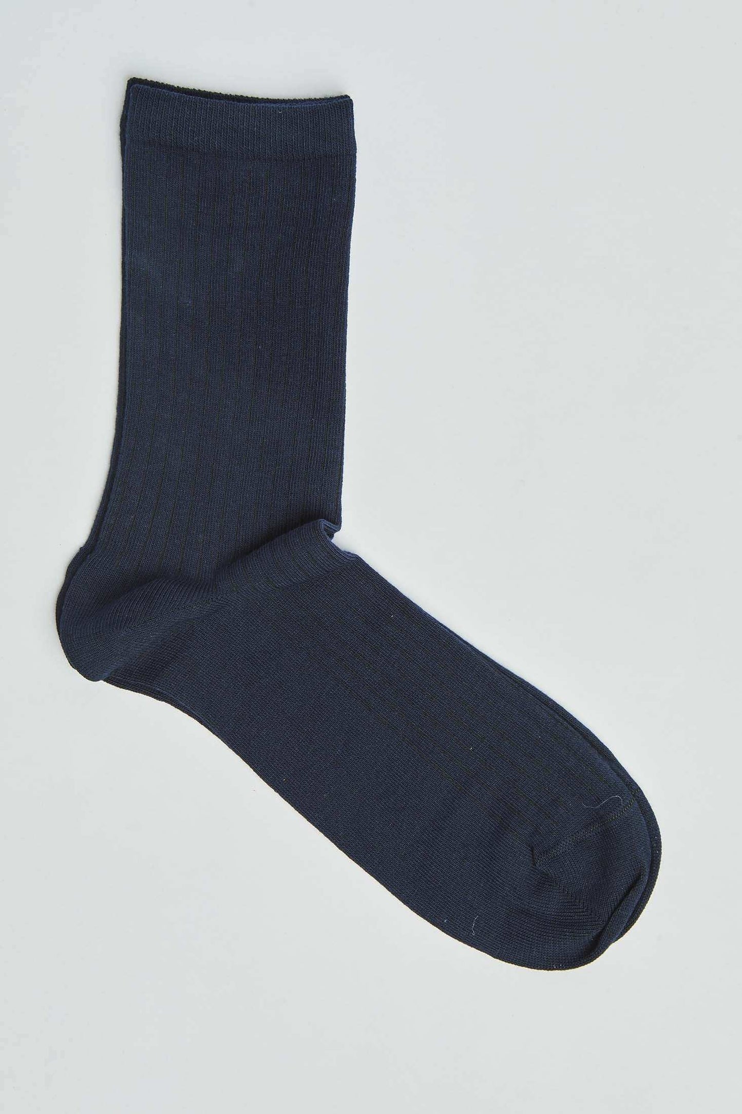 Plain navy blue ribbed crew sock on a white background