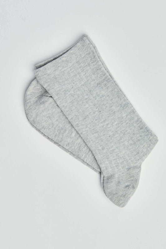 Pair of plain light grey crew socks on a white background