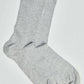 Pair of light grey cotton crew socks on white background