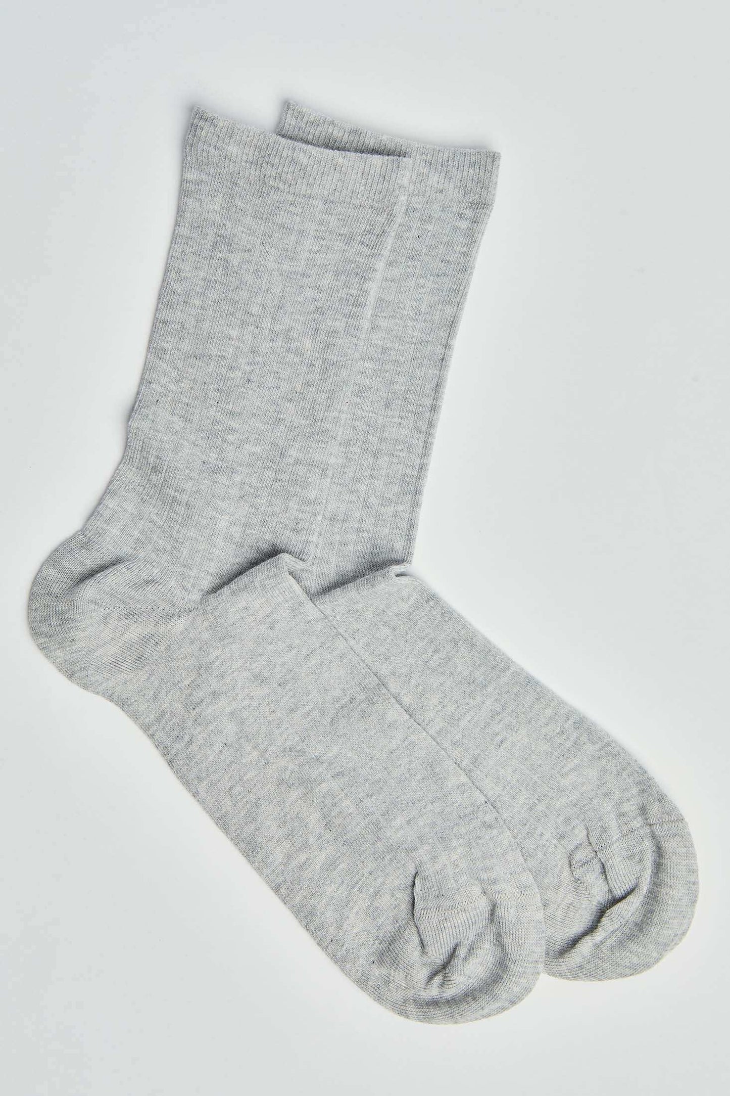 Pair of light grey cotton crew socks on white background