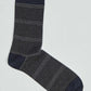 Navy blue sock with thin white and grey stripes, casual men's fashion accessory