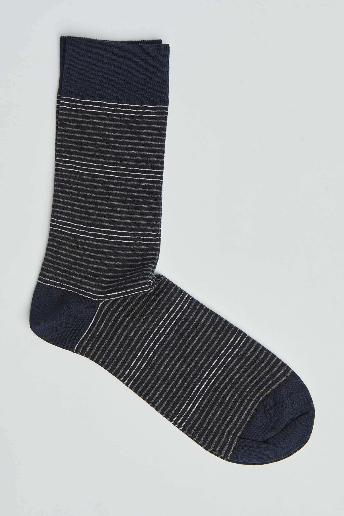 Navy blue sock with thin white and grey stripes, casual men's fashion accessory