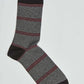 Men’s striped dress sock in black, grey, and red with reinforced toe and heel.