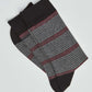 Pair of men's striped socks in black, grey, and red on white background