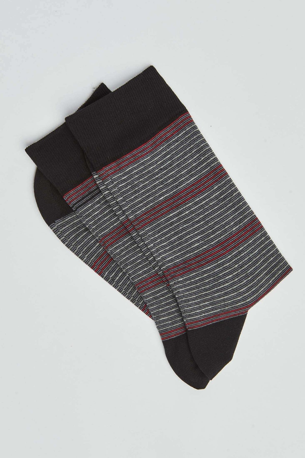 Pair of men's striped socks in black, grey, and red on white background