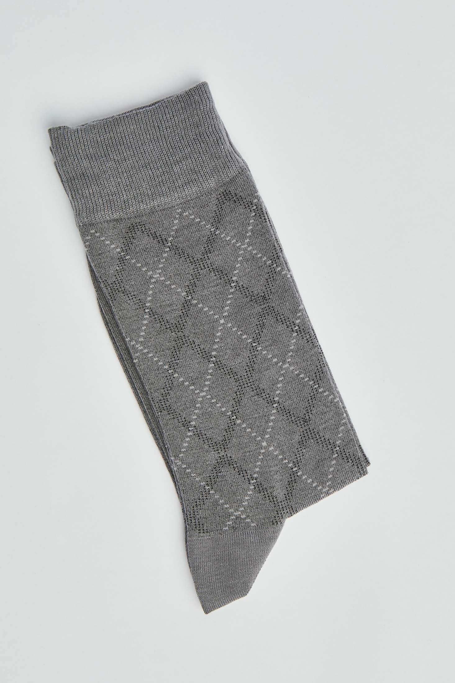 Folded grey argyle socks with a diamond pattern on a white background
