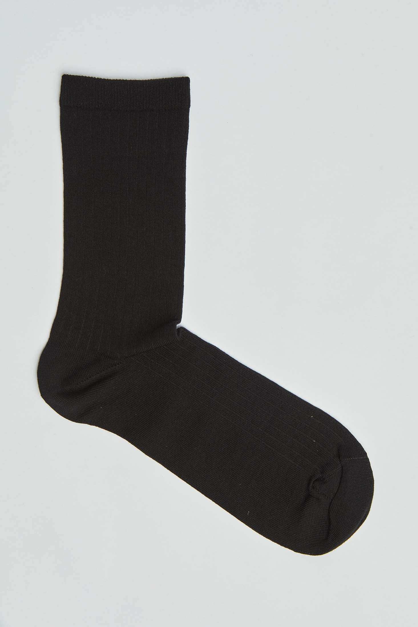 Black cotton crew sock on plain white background, casual men's or women's hosiery