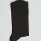 Folded black ribbed dress sock on a plain white background