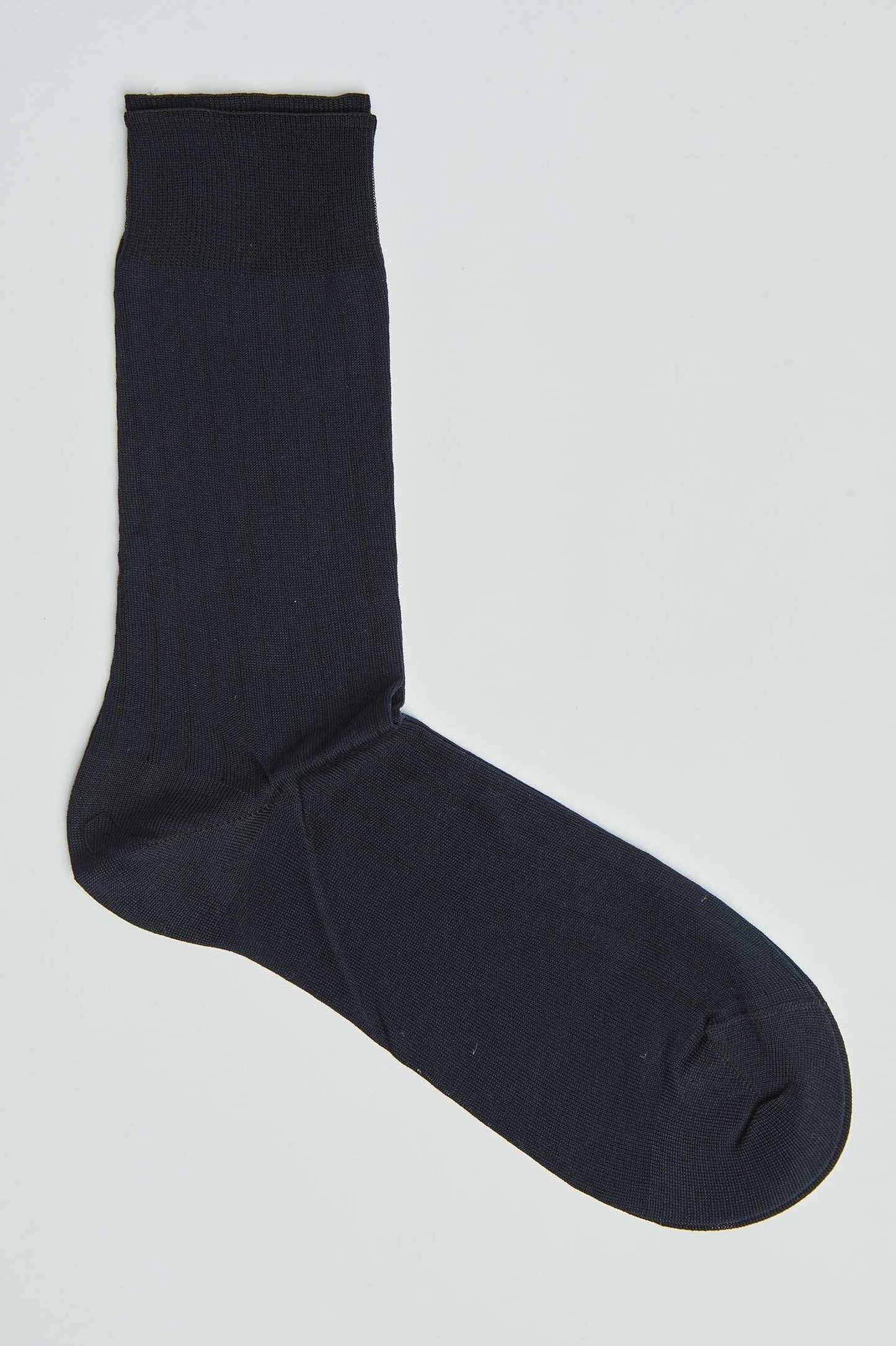 Black men's dress sock laid flat on a white background