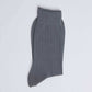 Folded gray ribbed sock on white background, casual men's or women's wear
