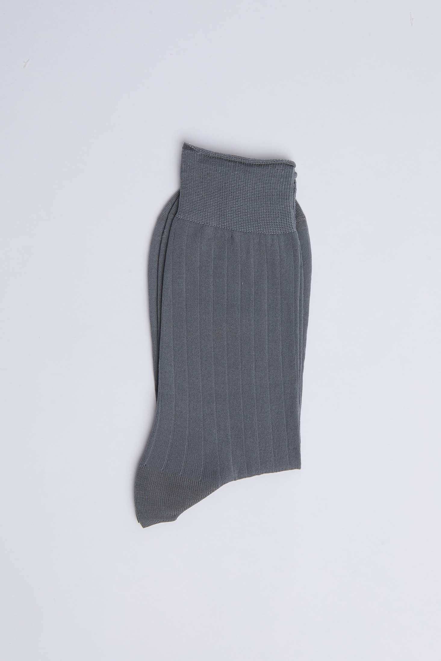 Folded gray ribbed sock on white background, casual men's or women's wear