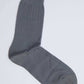 Single gray ribbed men's dress sock on a plain white background