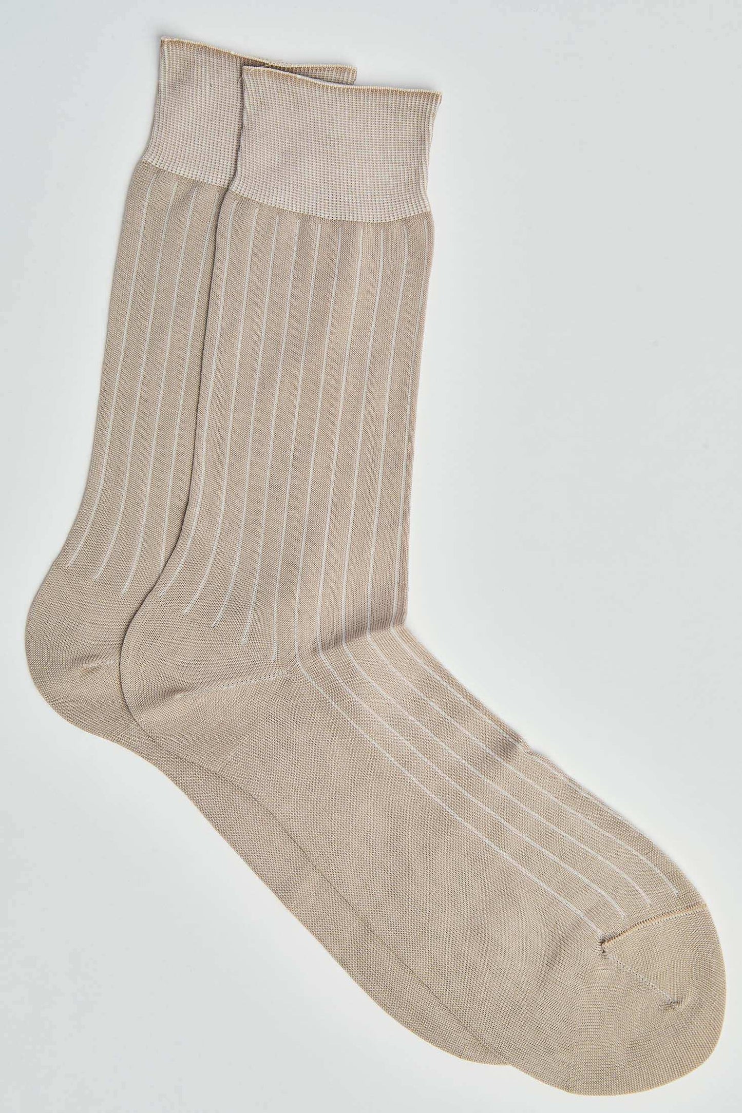 Beige ribbed crew socks with white vertical stripes on a plain background