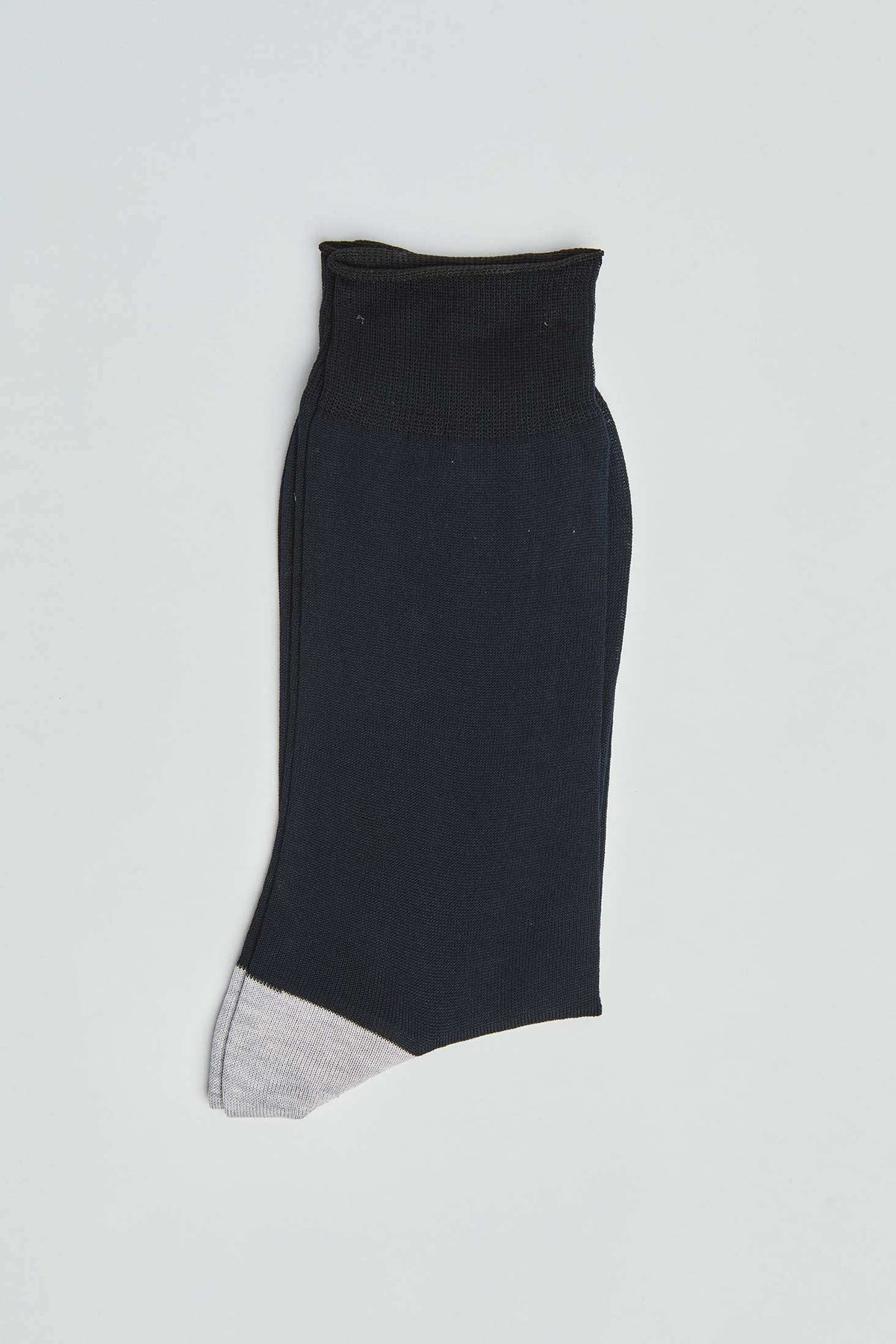 Black ankle sock with a light gray toe, casual men's fashion accessory on plain background