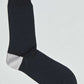 Black crew sock with contrasting light gray heel on white background
