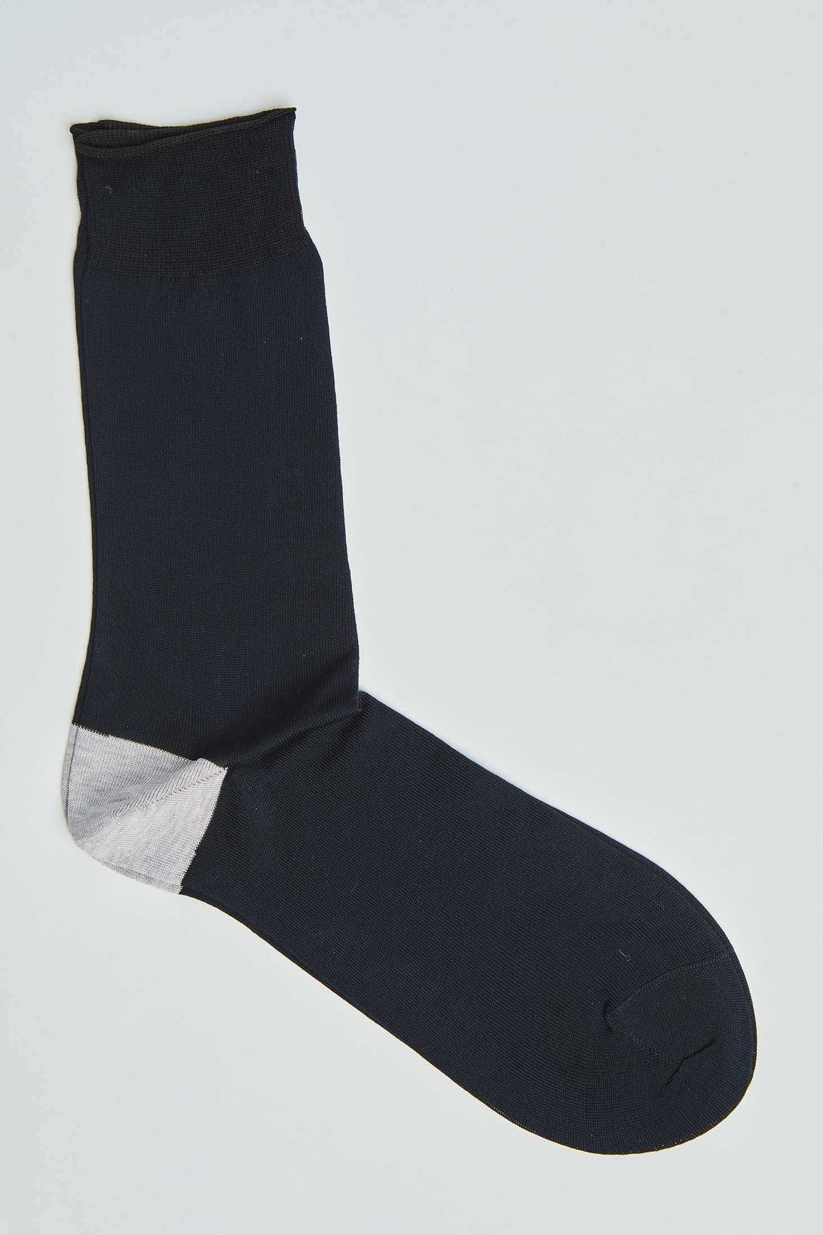 Black crew sock with contrasting light gray heel on white background