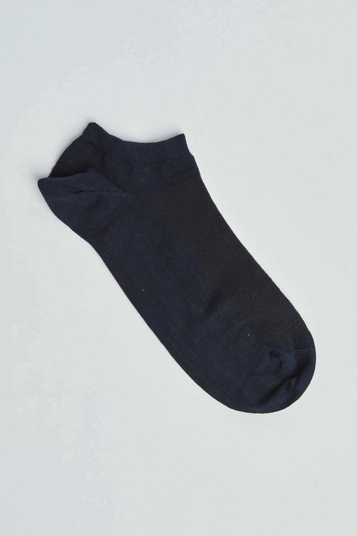 Black ankle sock on plain white background, casual men's and women's footwear