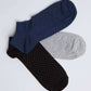 Set of three polka dot ankle socks in navy, gray, and black on white background