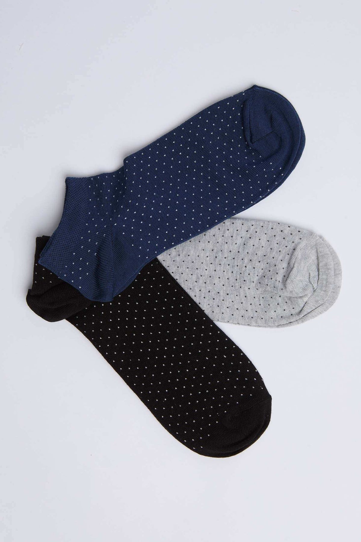 Set of three polka dot ankle socks in navy, gray, and black on white background