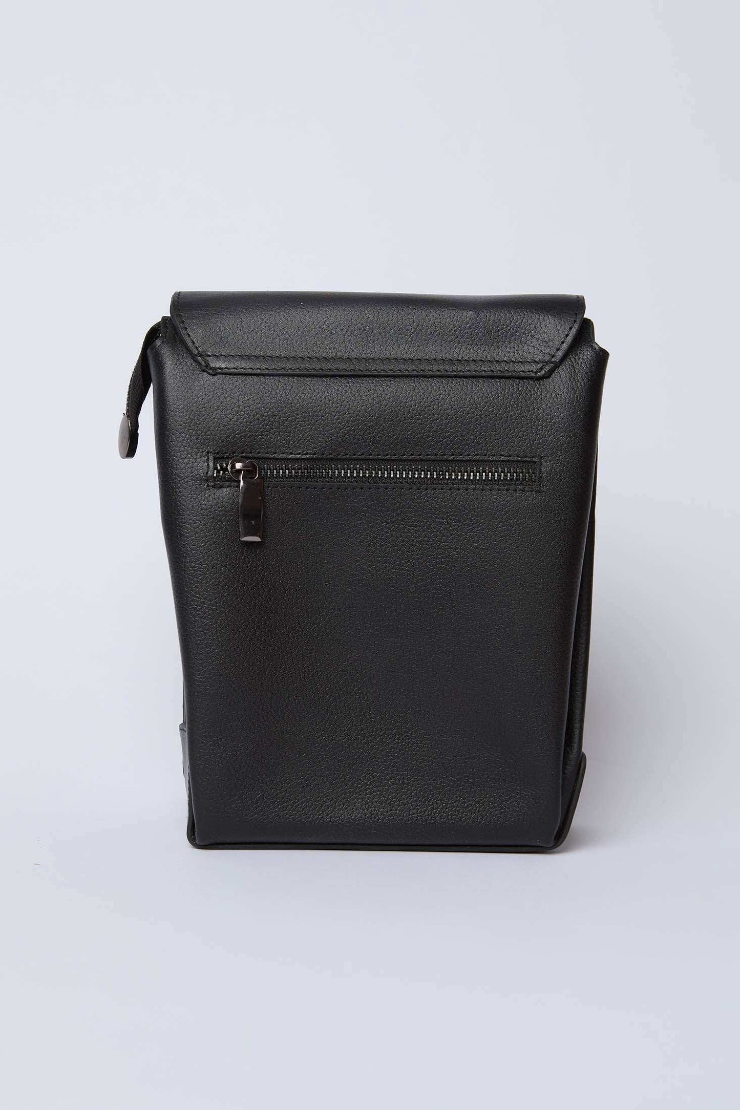 Dalydress black leather sling bag with front zipper pocket on white background