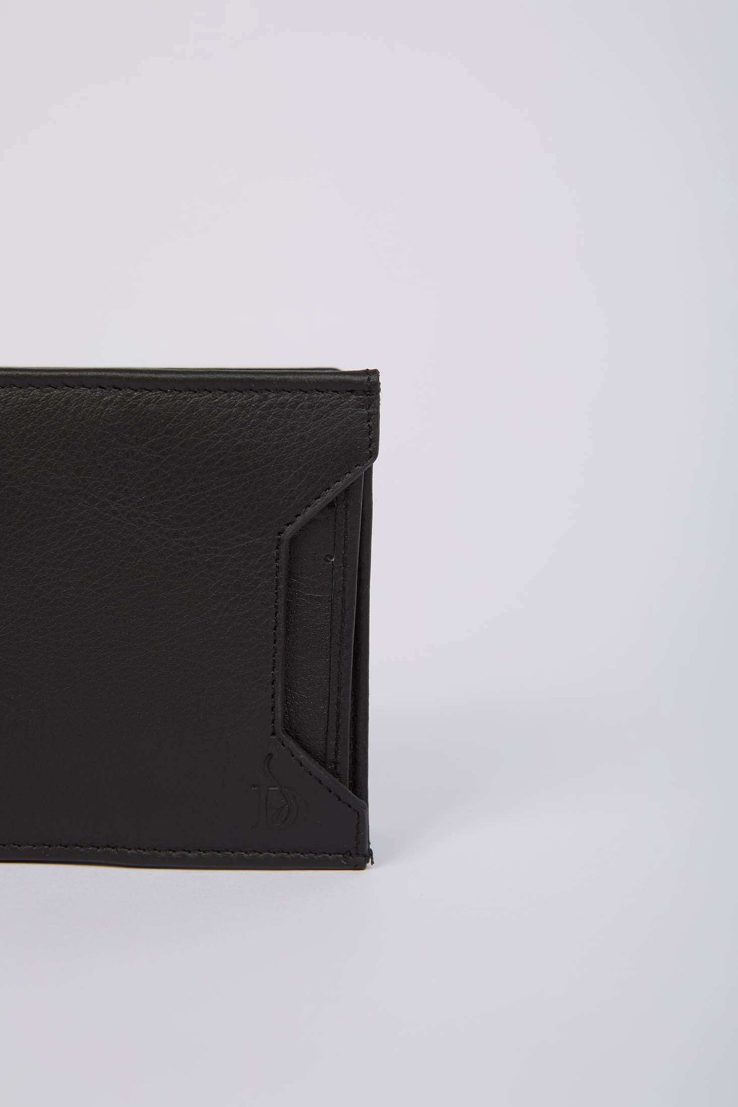 Dalydress black leather men's wallet with textured finish on a light background