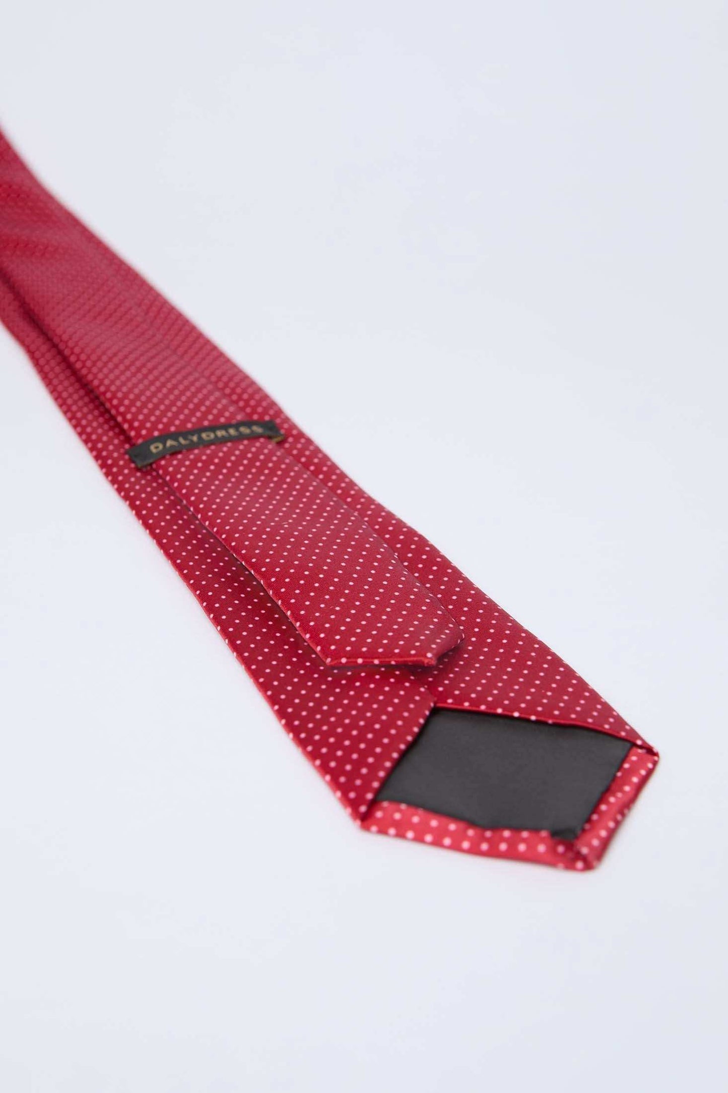 Dalydress red polka dot men's tie on white background, elegant formal accessory