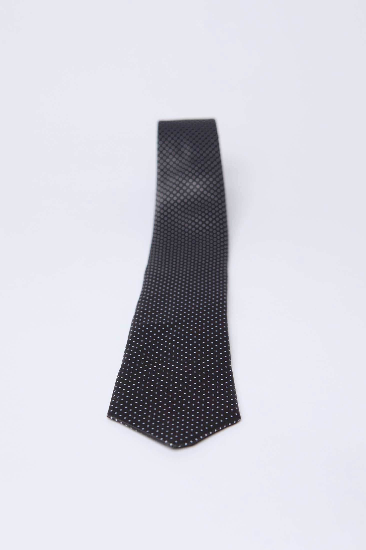 Dalydress men's black tie with small white polka dots on a plain background