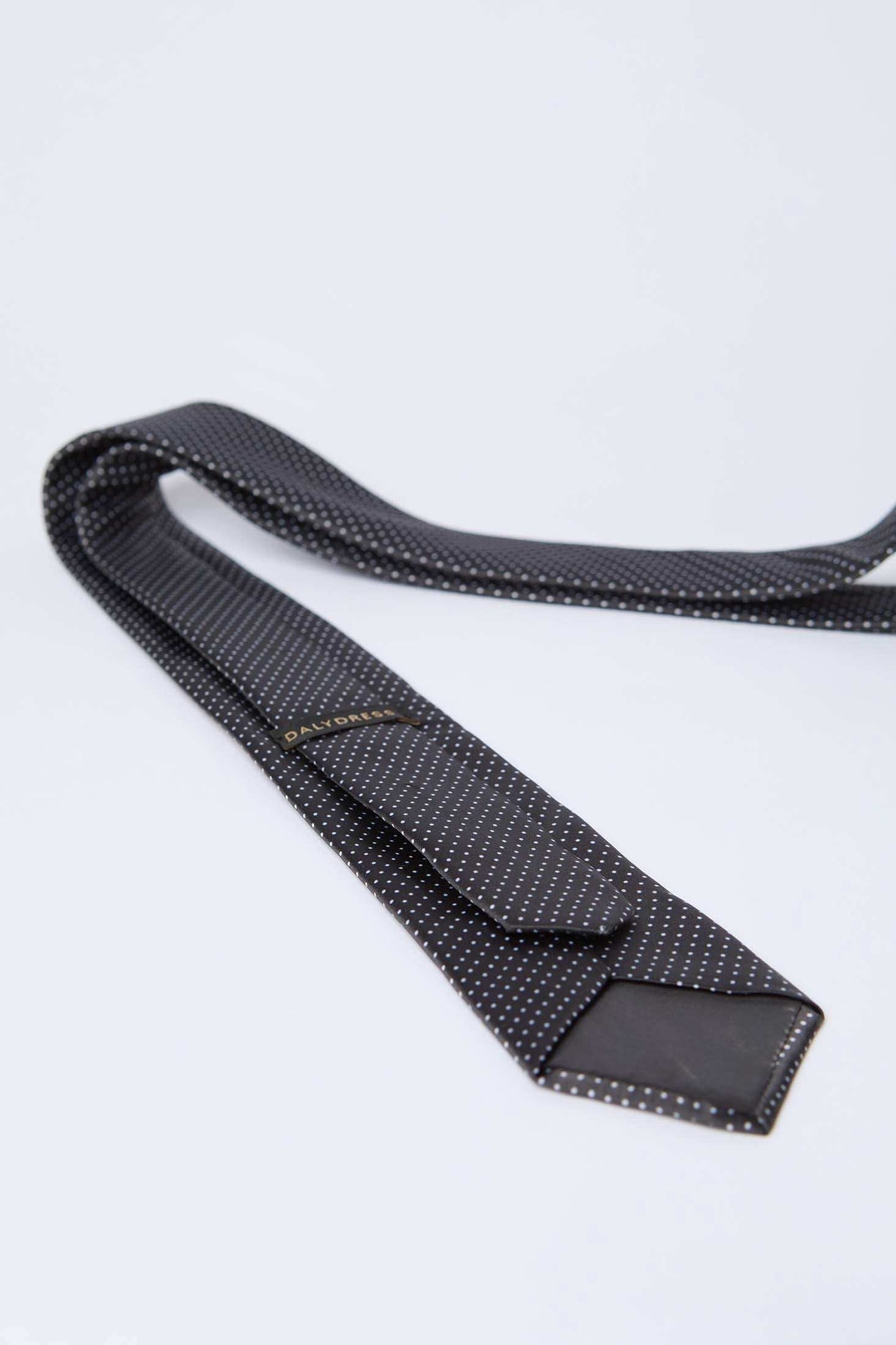 Dalydress black polka dot men's tie on white background, elegant formal wear accessory