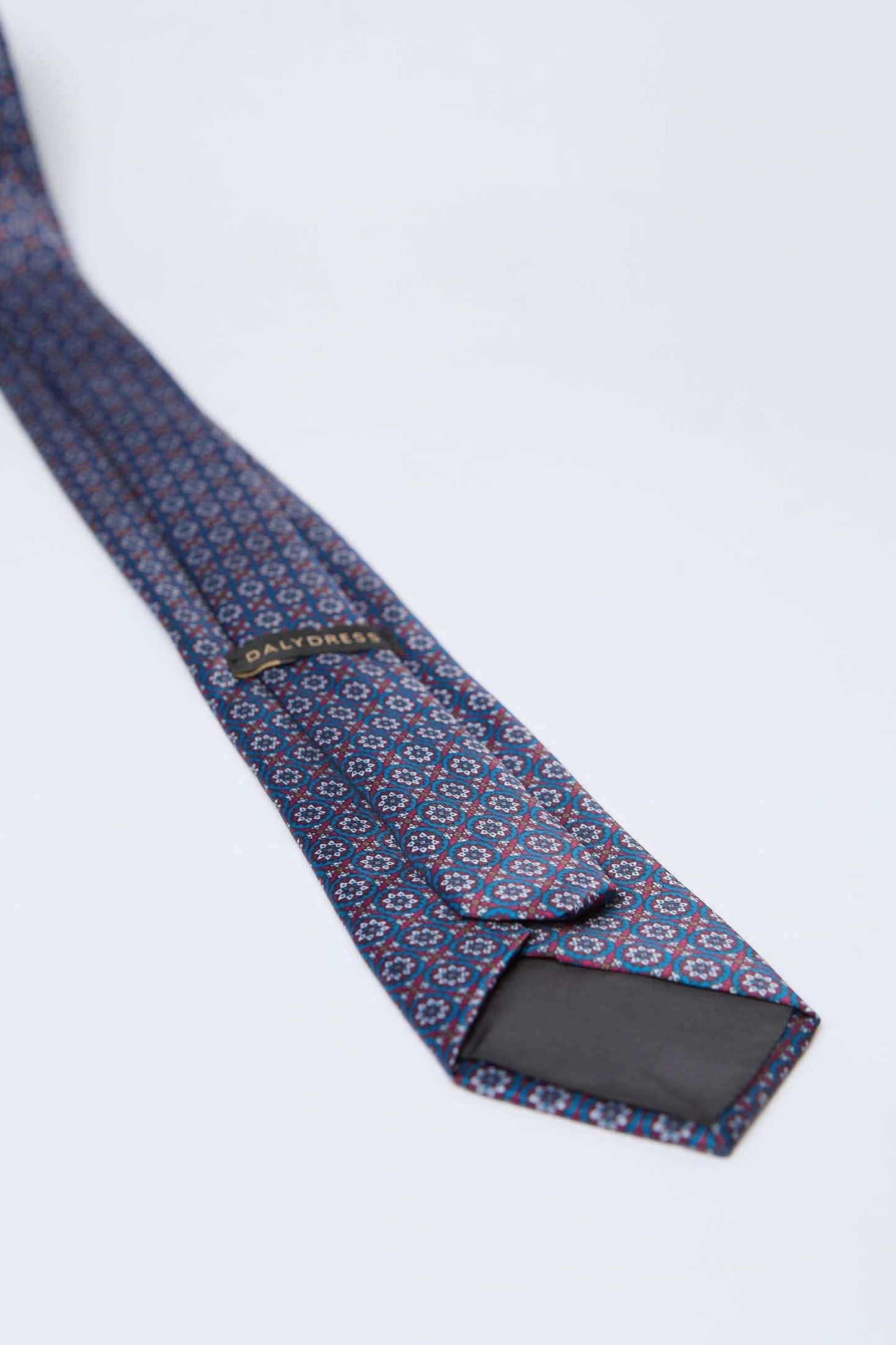 Dalydress men's blue patterned necktie with geometric design on a white background